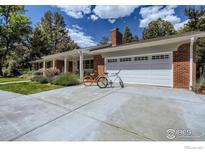 Brick ranch house with attached garage and landscaping at 5067 Cottonwood Dr, Boulder, CO 80301