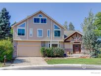 Two-story home with tan siding and a large garage at 114 E 14Th Ct, Broomfield, CO 80020