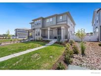 Two story home with front porch and landscaped yard at 2423 Whistler Dr, Longmont, CO 80504
