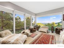 Bright living room with panoramic mountain views and comfy seating at 271 Anemone Dr, Boulder, CO 80302