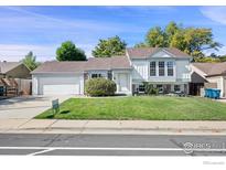 House exterior with a two-car garage and manicured lawn at 177 S Polk Ave, Louisville, CO 80027