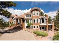 Two-story house with stone facade and large windows at 1189 Rembrandt Rd, Boulder, CO 80302