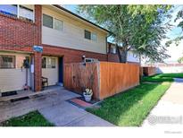 Brick townhouse with a fenced yard and walkway at 8047 Wolff St # F, Westminster, CO 80031