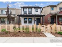 Two-story home with white siding, black accents, and picket fence at 125 Mesa Way, Superior, CO 80027