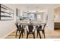 Open concept dining area with glass top table and black metal chairs at 18234 E Arizona Ave # D, Aurora, CO 80017