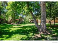 Spacious backyard with lush lawn and mature trees at 3776 Orange Ln, Boulder, CO 80304