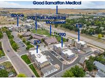 Aerial view of a residential community with multiple buildings and surrounding amenities at 290 S Cherrywood Dr # 204, Lafayette, CO 80026
