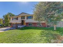 Two-story home with a two-car garage and well-maintained lawn at 2823 Mountain View Ave, Longmont, CO 80503