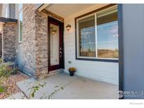 Inviting front porch with stone accents and a modern door at 9284 Gore St # D, Arvada, CO 80007