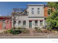 Two-story home with a rooftop deck and a landscaped front yard at 117 Elati St # 3, Denver, CO 80223