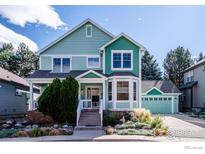 Two-story house with charming front porch and landscaping at 2116 Springs Pl, Longmont, CO 80504