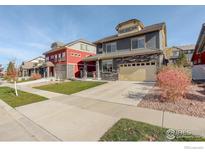 Exterior view of a beautiful two-story home with landscaping at 185 Pipit Lake Way, Erie, CO 80516