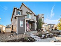 Two-story townhome with gray siding and front porch at 5316 Spalding Pl, Frederick, CO 80504