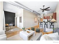 Bright living room with hardwood floors, comfy seating, and modern coffee table at 1555 Central St, Denver, CO 80211