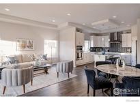 Modern kitchen featuring stainless steel appliances and an island with seating at 20411 E 53Rd Ave, Denver, CO 80249
