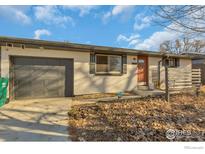 Updated Ranch home exterior boasts a fresh coat of paint and landscaping at 4670 Independence N St, Wheat Ridge, CO 80033