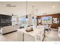 Modern kitchen with white cabinets, quartz countertops, and stainless steel appliances at 2929 South Flat Cir, Longmont, CO 80503