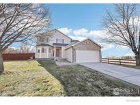 Two-story house with attached garage and landscaped yard at 4822 Barn Owl Dr, Frederick, CO 80504