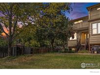 Evening view of charming townhome with well-manicured lawn and tree at 3405 Valmont Rd # A, Boulder, CO 80301