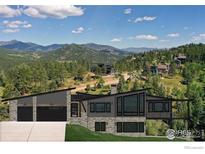 Modern home with three-car garage and stunning mountain views at 7142 Lynx Lair Rd, Evergreen, CO 80439