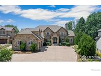 Stunning stone house with a large driveway and landscaping at 1615 Stardance Cir, Longmont, CO 80504