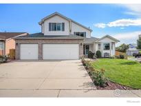 Two-story house with three-car garage and landscaped yard at 2292 Brantner Pl, Brighton, CO 80601