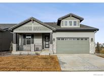 Craftsman style home with gray siding, stone accents, and a two-car garage at 3051 Newfound Lake Rd, Berthoud, CO 80513