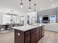 Spacious kitchen boasts an island, stainless steel appliances, and hardwood floors at 3051 Newfound Lake Rd, Berthoud, CO 80513