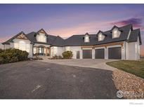 Stunning two-story home with a three-car garage and landscaped grounds at 3796 Vale View Ln, Mead, CO 80542