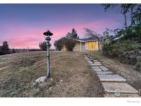 Stone pathway leads to a charming mid-century home with a beautiful sunset view at 34 S Raleigh St, Denver, CO 80219