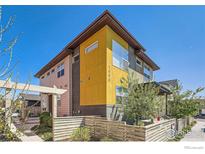 Modern two-story home with a yellow accent wall and wood fence at 1998 Foxtail Ln # B, Lafayette, CO 80026