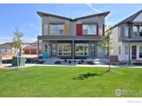 Modern two-story townhome with front porch and lawn at 440 Levi Ln # A, Lafayette, CO 80026