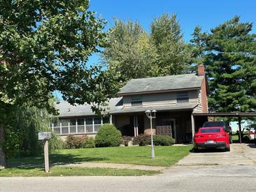 Ranch-style home with carport and well-maintained lawn at 643 Pratt St, Greenfield, IN 46140