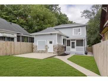 House with backyard, stone patio and wooden fence at 1136 W 35Th St, Indianapolis, IN 46208