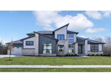 Modern two-story home with stone and siding accents, showcasing a stylish design at 9280 Highpointe Ln, Zionsville, IN 46077