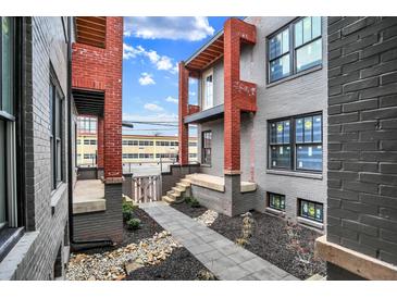 Brick building courtyard with walkway, landscaping, and gated entrance at 723 N Cleveland St, Indianapolis, IN 46202