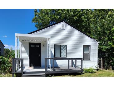 White house with black accents, covered porch, and deck at 3106 Newton Ave, Indianapolis, IN 46201