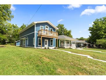 Two-story home with a balcony, freshly painted at 1126 W 35Th St, Indianapolis, IN 46208
