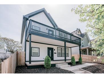 Stunning two-story home with a modern farmhouse design, featuring a black and white color scheme and a large front porch at 221 Eastern Ave, Indianapolis, IN 46201