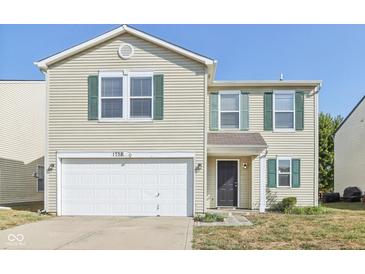 Two-story house with beige siding, green shutters, and a white garage door at 1738 Sonesta Way, Indianapolis, IN 46217