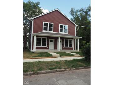 Two-story duplex with maroon siding and white trim at 217 N Temple Ave, Indianapolis, IN 46201