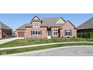 Brick house with a two-car garage and landscaped yard at 4212 Stone Lake Dr, Zionsville, IN 46077