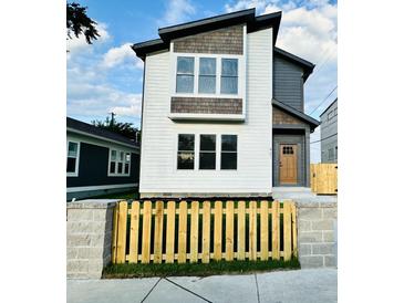 Modern two-story house with a wood fence and stone accents at 421 S Randolph St, Indianapolis, IN 46201