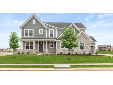 Two-story house with gray siding, stone accents, and a landscaped lawn at 15287 Garden Mist Pl, Fishers, IN 46037