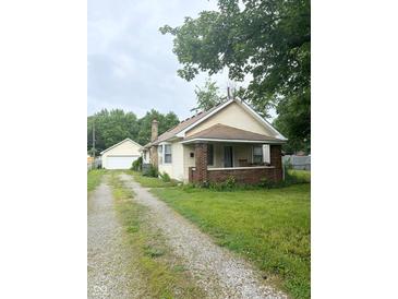 House exterior with driveway, garage and front yard at 1062 N Berwick Ave, Indianapolis, IN 46222