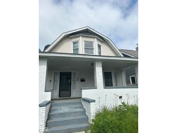 Two-story house with white brick and a covered porch at 20 N Pershing Ave, Indianapolis, IN 46222