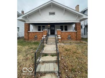 Charming craftsman home with brick details and porch at 57 N Tremont St, Indianapolis, IN 46222