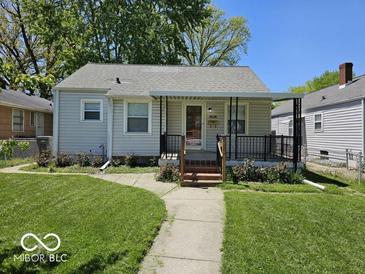 House with gray siding, small porch, and green lawn at 1618 N Linwood Ave, Indianapolis, IN 46218
