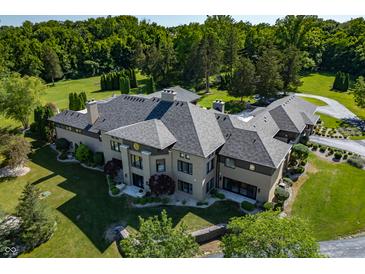 Luxury home with a large backyard, expansive lawn, and a stunning gray roof at 4023 Cedar Hills N Dr, Greenwood, IN 46143