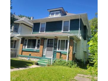 Two-story home with green and yellow siding at 3526 N Capitol Ave, Indianapolis, IN 46208